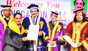 Chaudhary Devi Lal University University Vice Chancellor Radhe Sham Sharma gives a degree to a student in CMK National PG College for Women in Sirsa on Thursday.