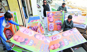 Workers prepare BJP posters and banners for the Lok Sabha elections at a workshop in Jammu.