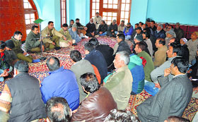 Police officials hold a public meeting in the Pir Bagh area of Khanyar in Srinagar on Thursday.
