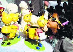 Cute nothings: A girl kisses an ornamental flower pot during a flower show at the PAU in Ludhiana on Thursday