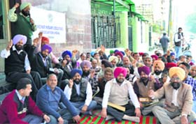 BSNL employees shout slogans outside the general manager’s office in Ludhiana on Thursday
