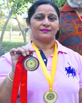 Rajinder Kaur poses with her medals