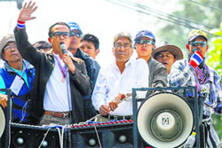 Satish Sehgal (C) joins anti- government protesters atop a truck in Bangkok on January 22, 2014.