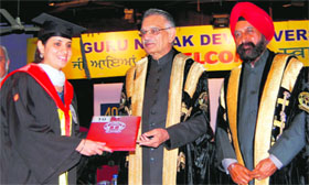 Punjab Governor Shivraj Patil (centre) awards a degree to a student during the annual convocation of Guru Nanak Dev University in Amritsar on Friday.