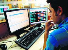 A trader monitors share prices at a brokerage house in Mumbai on Friday.