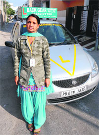 Krishan Sharma with her car in Bathinda.