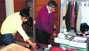 A family checks the ransacked room at a flat in Zirakpur on Friday.