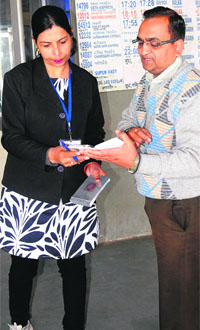 Senior travelling ticket examiner Mukesh Solanki checks the platform ticket of a person at the Chandigarh railway station.
