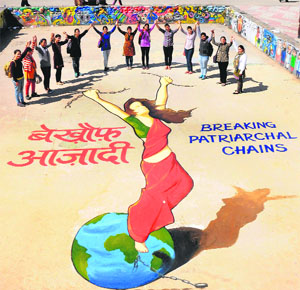 Girl students form a chain near an art work depicting the freedom of women on the eve of International Womens Day at Panjab University in Chandigarh on Friday.