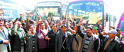 HRTC employees raise slogans in support of their demands in Shimla on Friday