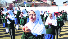 Pray time: Students attend their assembly after reopening of schools in Srinagar on Friday. Tribune photo: Amin War