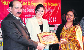 A young achiever being honoured on the eve of Womans Day at Government College for Women, Parade, in Jammu on Friday.