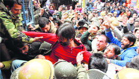 Police detain JKLF chairman Yasin Malik and his party activists in Srinagar on Friday.