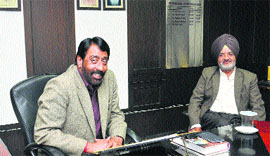 Mayor Sunil Jyoti sits in his office, with pictures of political leaders on display even two days after the implementation of the code of conduct in Jalandhar on Friday.