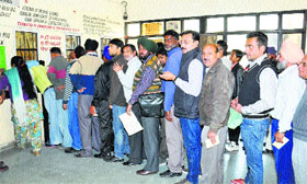 Applicants of driving licences and registration certificates stand in a long queue as the windows opened after 15 days after the strike of the clerical staff in Jalandhar on Friday.