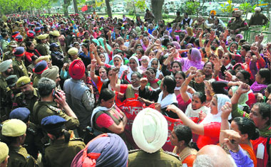 Anganwadi workers shout slogans against the state government in Bathinda on Saturday.