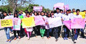 Volunteers take part in a walkathon at Sukhna Lake in Chandigarh on Saturday