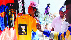 AAP volunteers put a stall to sell T-shirts imprinted with the party slogans ahead of the forthcoming Lok Sabha elections, at Jantar Mantar in New Delhi on Saturday