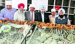 SS Channy (fourth from right), Principal Secretary, Cultural Affairs Department, looks at the remains of the martyrs in Ajnala on Saturday