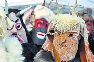 A group of masked men "Zamarron" parade during the carnival in Piasca, Spain. Derived from ancient folklore, the zamarrones, dressed in white masks and skins chase children with a broom