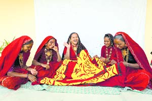 Business and bonhomie: Rami Ben (centre) shares a lighter moment with members of the Self-Help Group at the Okhai Centre in Mithapur
