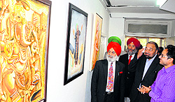 President, Indian Academy of Fine Arts, Rajinder Mohan Singh Chinna, takes a look at the paintings on display at the exhibition in Amritsar on Sunday