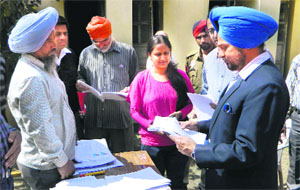 Mohali Deputy Commissioner Tejinder Pal Sidhu at a polling booth in Sohana village on Sunday. 