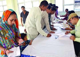 People submit papers to get an ID card during the special camps for voters in East Delhi on Sunday