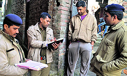 Policemen doing the verification of local tenants at Rajesh Colony in Dehradun on Sunday