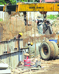 Workers constructing the Bikram Chowk-Gandhi Nagar flyover illegally using a domestic LPG cylinder for fuelling cutting machines in Jammu. 