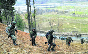 Army jawans conducting a search operation on Sunday for the militants who had attacked a patrol party of the Rashtriya Rifles at Khushipora in Baramulla district on Saturday.