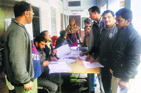 New voters register themselves with poll officials at Talwara in Hoshiarpur district on Sunday.