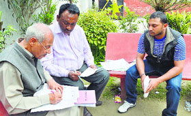 Poll officers make corrections in the voter list at a school in Ludhiana on Sunday.