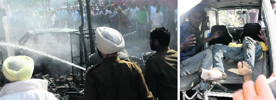 Firemen douse the flames on the spot where the blast occured; and (right) the injured being taken to a hospital in Bathinda on Monday. Tribune photos