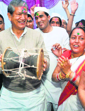 Chief Minister Harish Rawat participates in a Holi milan programme in Dehradun on Sunday.