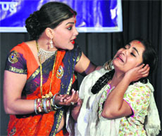 Artistes perform a play on womens harrasment at Town Hall in Dehradun on Monday. 