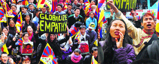 Tibetan supporters hold placards during a rally organised on the occasion of Tibetan National Uprising Day at Dharamsala on Monday.