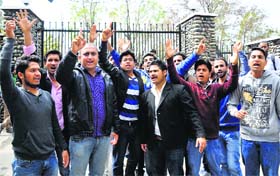 Students protest at the main gate of the University of Jammu on Monday