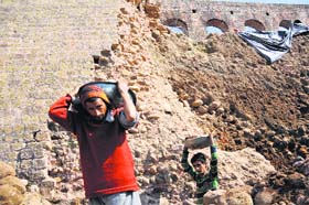 Labourers at work in Bahu Fort in Jammu