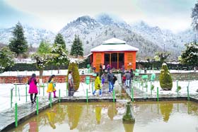 Leisure walk: Tourists at the Chesma Shahi Garden after a snowfall in Srinagar on Monday