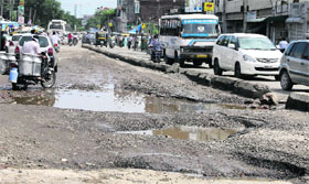 Potholes widened after the recent rains near the bus stand in Jalandhar.