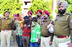 Accused in police custody at the Salem Tabri police station in Ludhiana on Monday. Photo: Inderjeet Verma
