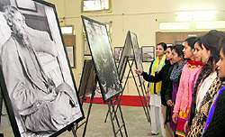 Students of MKP Womens College watch a photo exhibition on Rabindranath Tagore in Dehradun on Tuesday