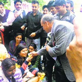 Dr JS Jakhar, chairperson of law department of Chaudhary Devi Lal University, offers juice to striking students in Sirsa on Tuesday