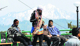 Tourists enjoy the cool weather in Shimla on Tuesday.