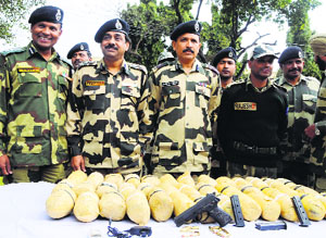 BSF officials with the heroin seized at Khasa near Amritsar on Tuesday. 