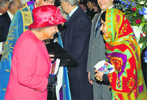 Britain's Queen Elizabeth II with Malala Yousafzai as they attend the Commonwealth Observance day multi-faith celebrations at Westminster Abbey, London. 