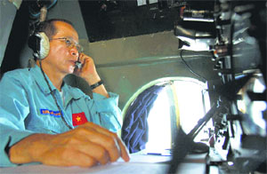 Vietnam Air Force Col Duong Van Lanh looks at the navigation control panel aboard aircraft Antonov An-26 during a search mission for the missing Malaysia Airlines Boeing 777 over water between Malaysia and Vietnam on Tuesday