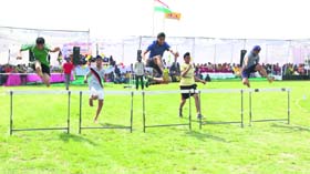 Students participate in a hurdle race during the Hola Mohalla celebrations at International Fateh Academy in Amritsar on Wednesday