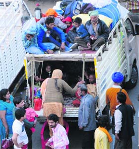 Religious fervour: Putting their lives in danger, devotees engage goods carrier from Amritsar to visit Wadhbhag Singh Dera on the occasion of Hola Mohalla on Wednesday